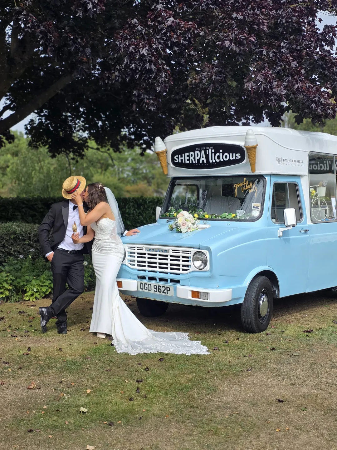 A wedding couple sharing a kiss beside the original Sherpa, shown as a monochrome print