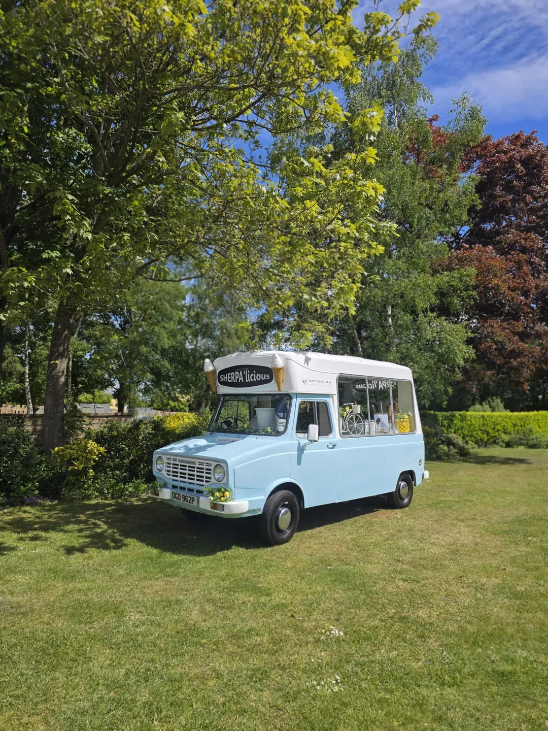The original pale-blue Sherpa’licious van in a sunny garden, shown as a colour print